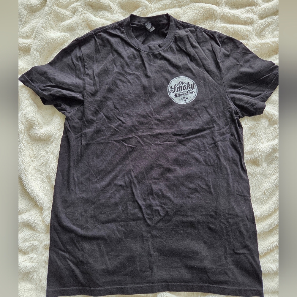 graphic t-shirt from Ole Smoky Moonshine. It features a circular white logo